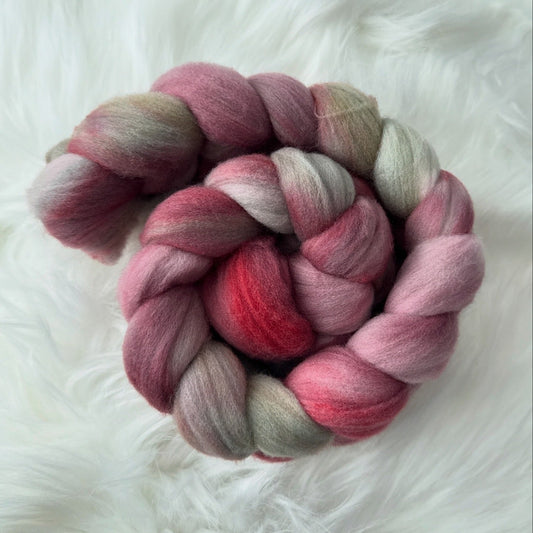 Multicolored braid of fiber on a white fluffy surface